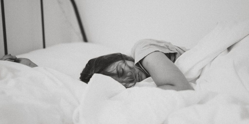 black and white image of young woman sleeping