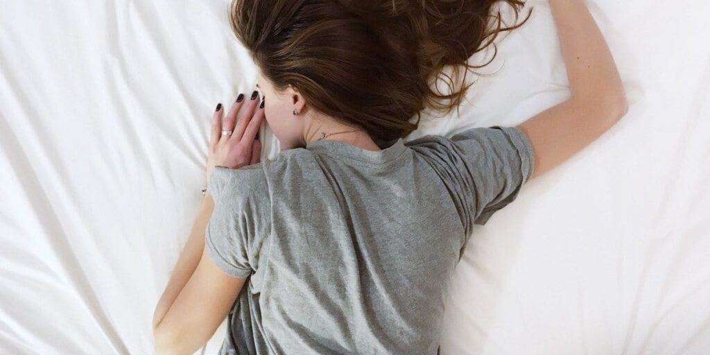 woman sleeping on bed