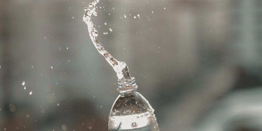 plastic water bottle being squeezed