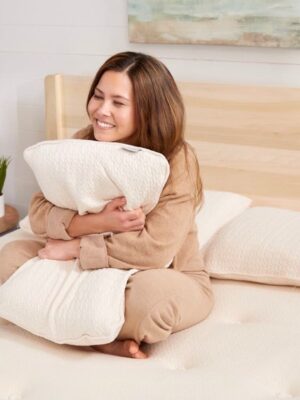 woman sitting on certified organic mattress