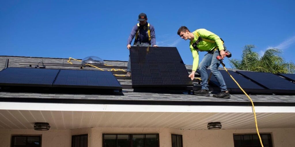 two men assessing how many solar panels to power a house