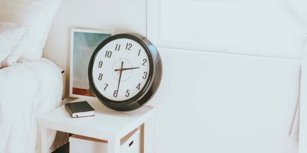 clock sitting on bedside table