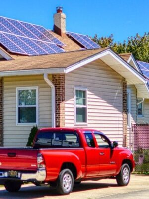 sunny view of home with solar panels on it