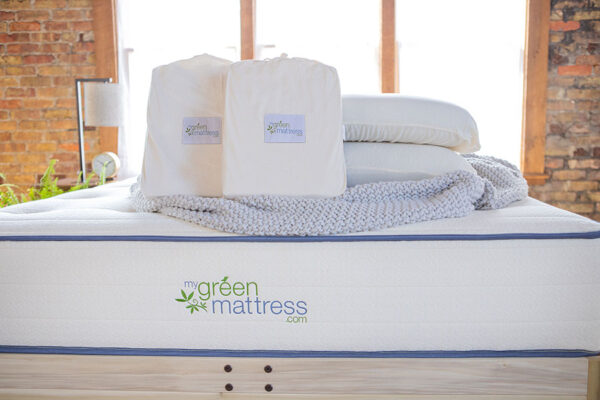 Organic cotton mattress protector packaging on bed