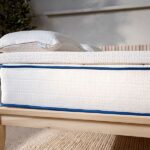 Side profile of organic latex mattress topper on bed showing detail