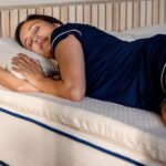 Close-up of woman sleeping on organic latex mattress topper showing natural texture