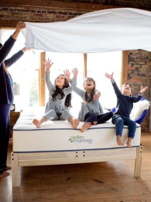 happy family sitting on mattress