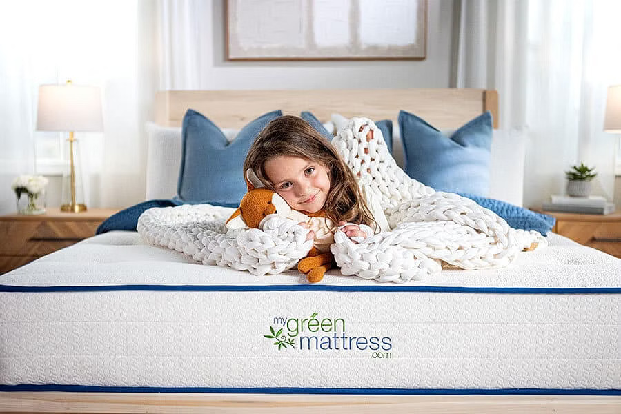 MGM_October2023-124-2 Child laying with stuffed animal on kiwi organic mattress in bright modern bedroom setting