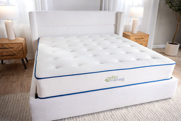 Natural Escape organic mattress displayed on bed frame in bright bedroom beside two night stands