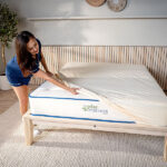 Woman making the bed with organic bedding bundle sheet set