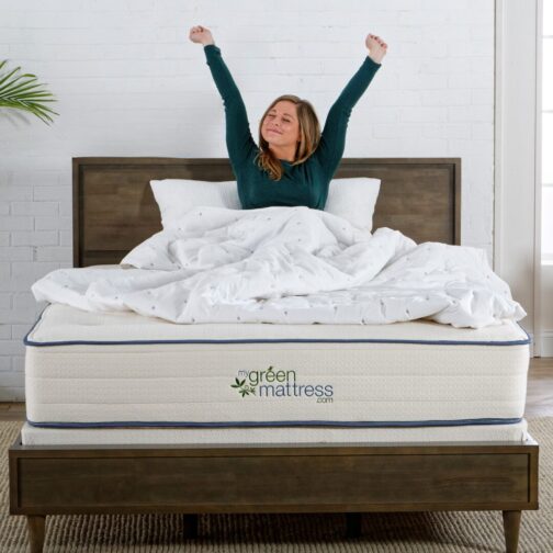 A woman stretching comfortably on the Natural Escape organic mattress, highlighting its enhanced support and pressure-relieving comfort.