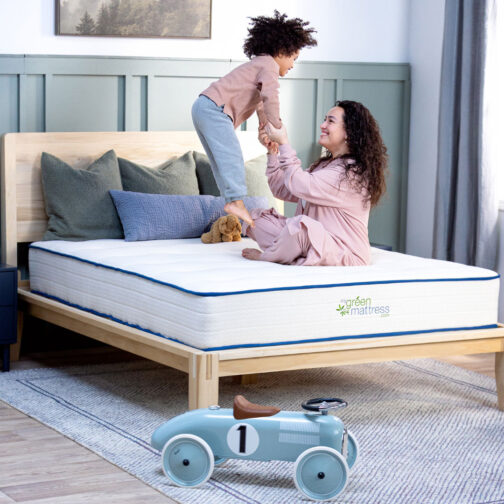 A mom and child playing on the Kiwi Organic Mattress, showcasing its nontoxic, family-safe materials.
