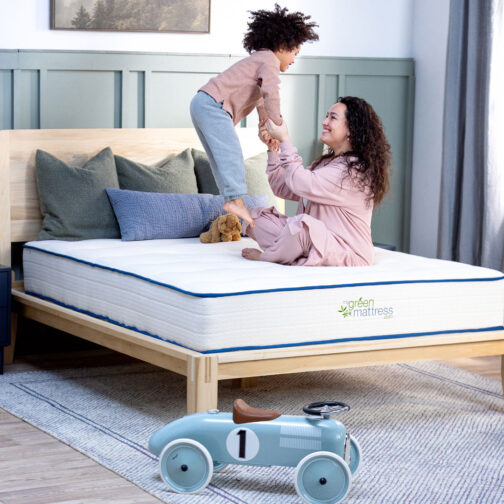A parent playing with their child on the Pure Eco Organic Kids Mattress, showcasing that it’s comfortable and supportive enough for parents too.