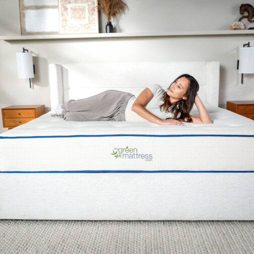 A woman relaxing on her side on the Kiwi Organic Mattress, highlighting the pressure-relieving comfort of its GOLS-certified organic latex layer.