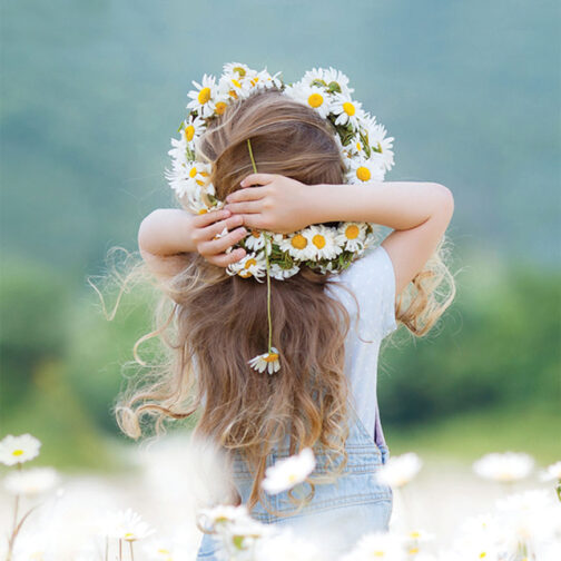 Little girl holding her hair in a field to highlight My Green Mattress products are environmentally friendly