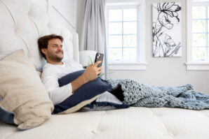 man-on-phone-while-sitting-in-bed