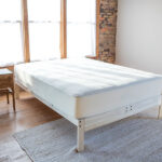 Organic cotton mattress protector on bed for breathable protection